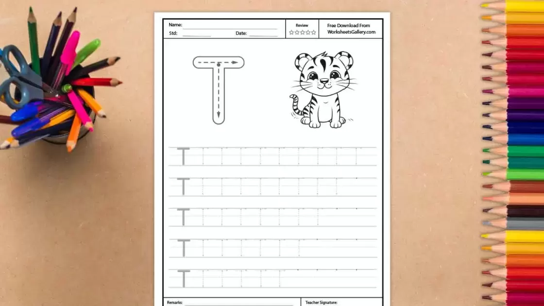 A white educational worksheet for tracing the uppercase letter T, featuring a large guide letter with directional arrows and a smiling cartoon tiger illustration, surrounded by a cup of colo